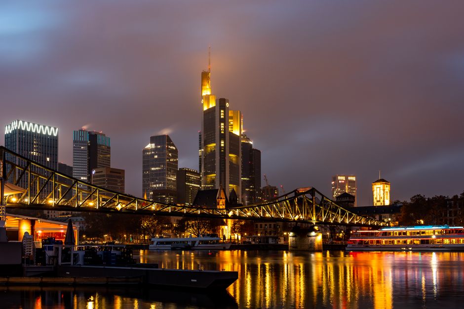 Captivating night skyline of Frankfurt with the iconic bridge and skyscrapers reflecting i