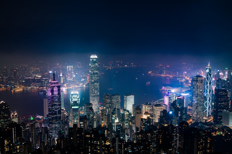 Captivating aerial view of Hong Kong's illuminated skyline with iconic skyscrapers at night.