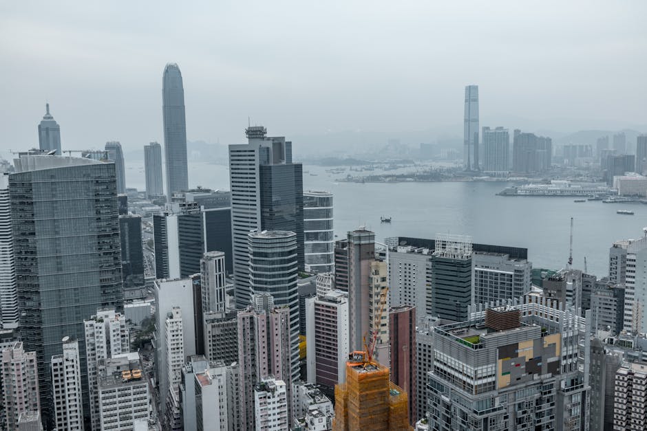 Elevated view of Hong Kong's modern skyscrapers and Victoria Harbor.