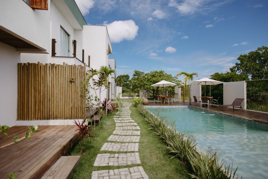 Stunning modern vacation home in Bahia, Brazil, featuring a pool and lush greenery.