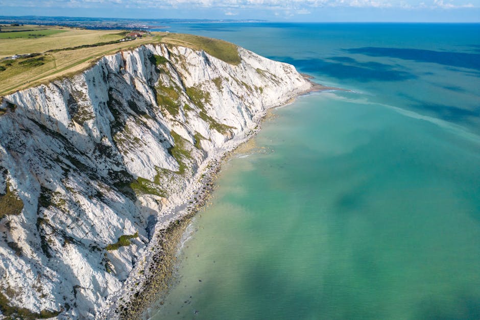Breathtaking aerial view of Eastbourne's white cliffs on a sunny day along the English Channel.