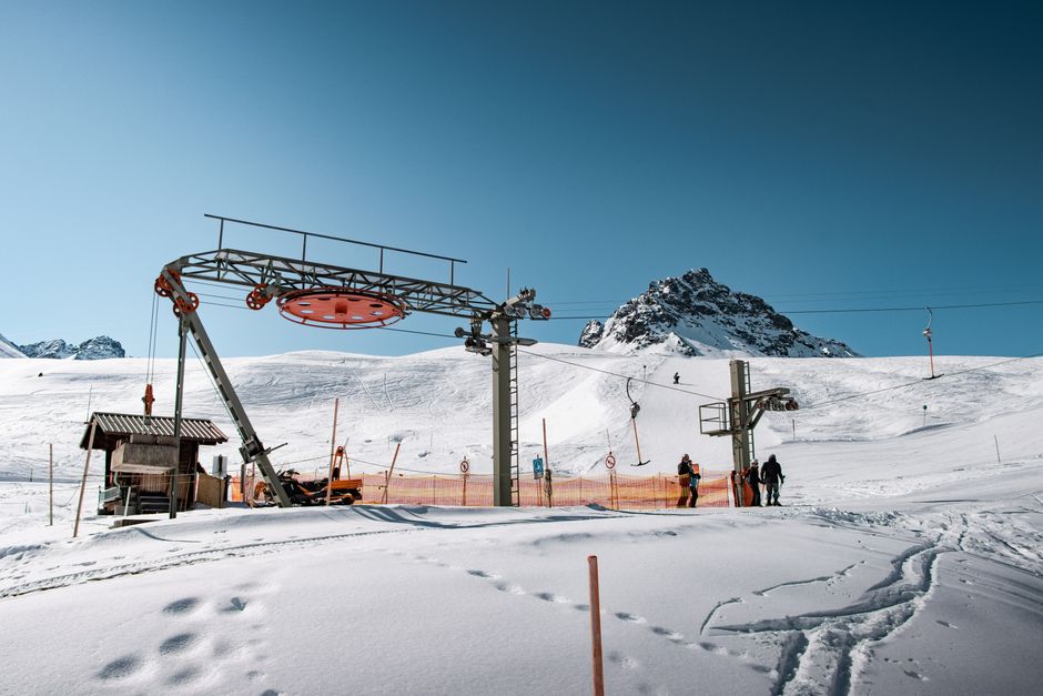 Ski lift in snowy mountains of Gaschurn, Austria, on a clear winter day.