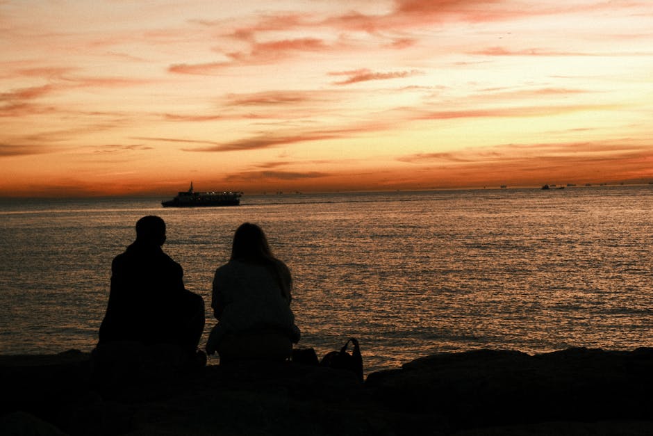Serene sunset view with silhouettes and ship on İstanbul's coast. Tranquil evening vibe.