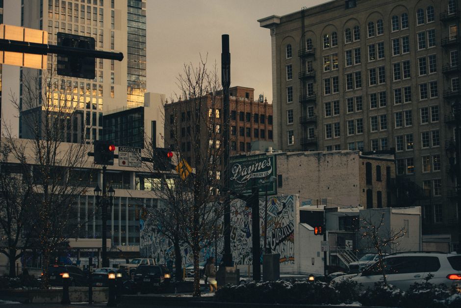 Street scene in downtown Salt Lake City with buildings and traffic lights during twilight.